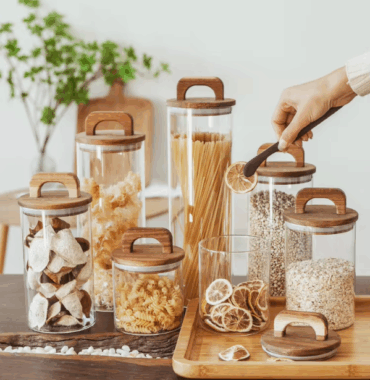 Transparent glass storage jars with sealed wooden lids