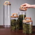 Transparent glass storage jars with sealed wooden lids