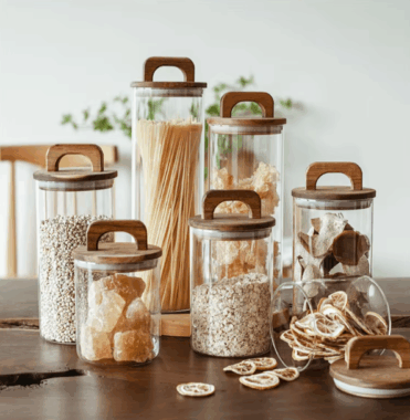 Transparent glass storage jars with sealed wooden lids
