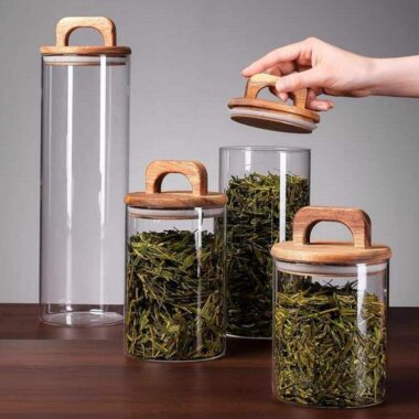 Transparent glass storage jars with sealed wooden lids