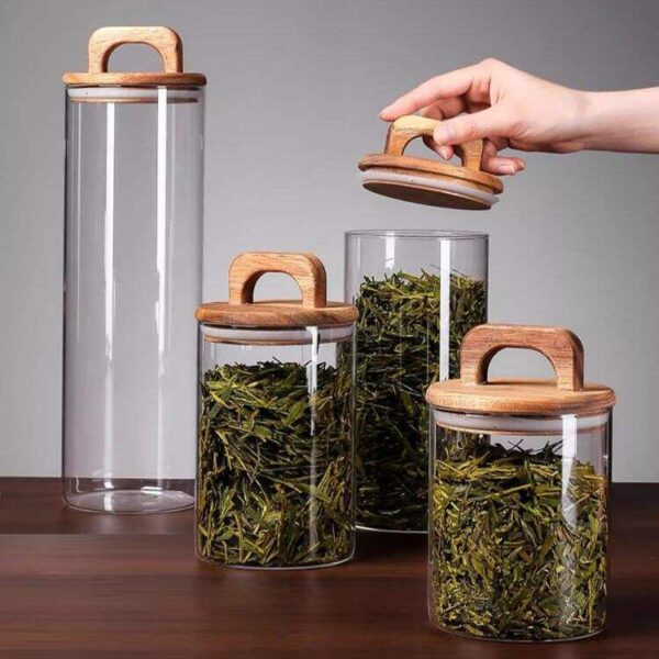 Transparent glass storage jars with sealed wooden lids
