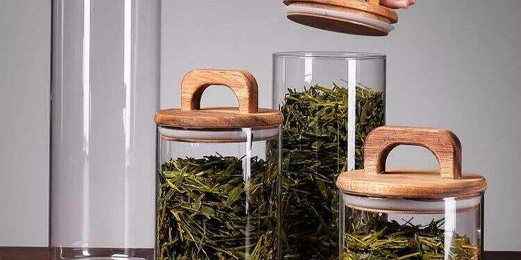 Transparent glass storage jars with sealed wooden lids