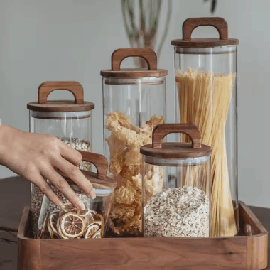Transparent glass storage jars with sealed wooden lids
